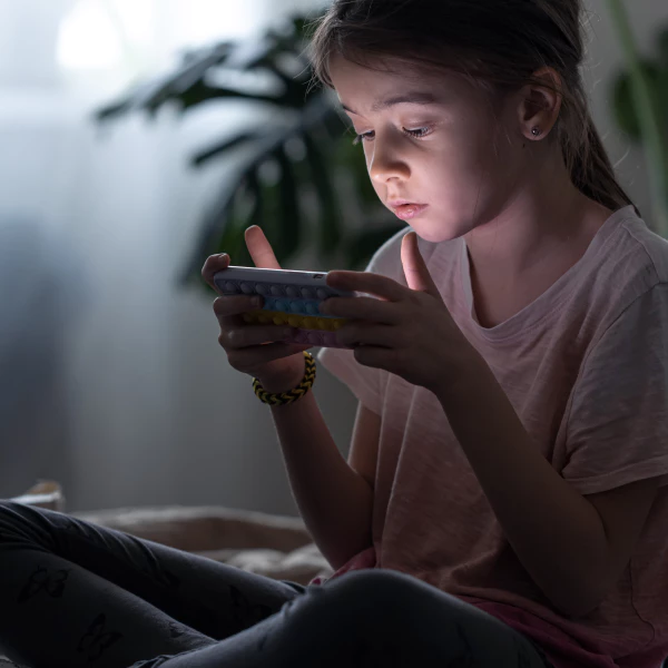 A little girl browsing 18+ content on a phone